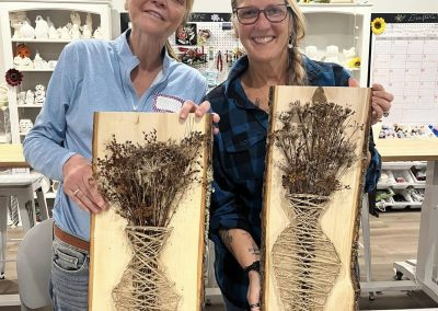Dried flowers in string art vase by two women in Crafters on Central