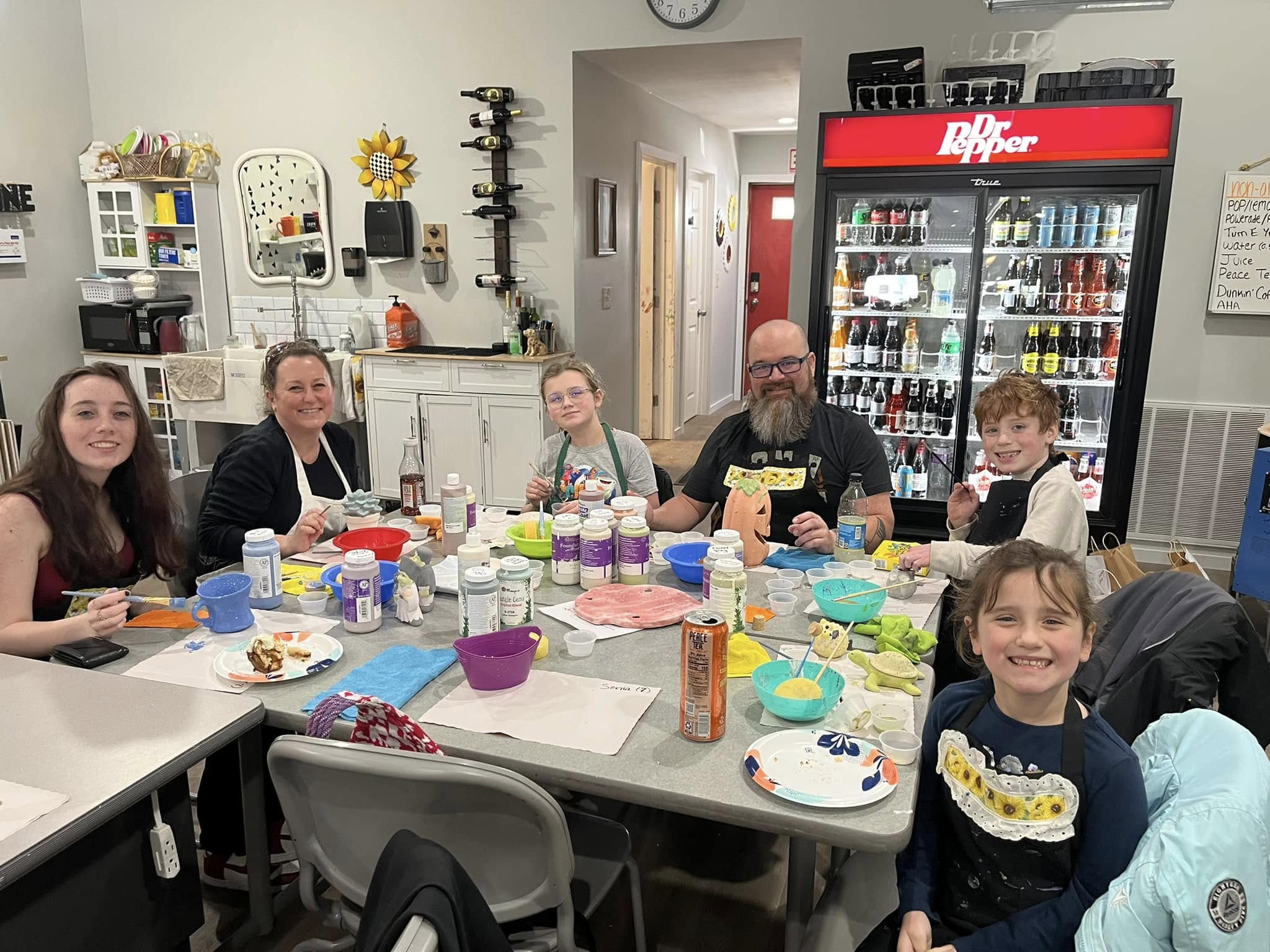 Family painting pottery at Crafters on Central
